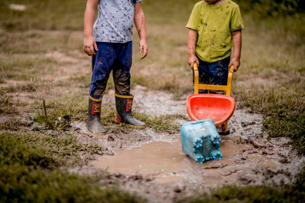 istock Children playing in muddy ponds 1267675917