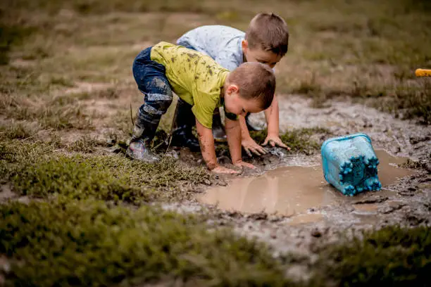 Photo of Children playing in mud