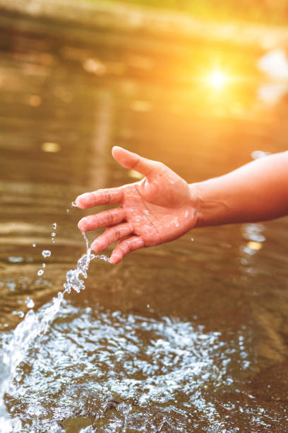 istock Hand fetch water and have water splash. 1267676294