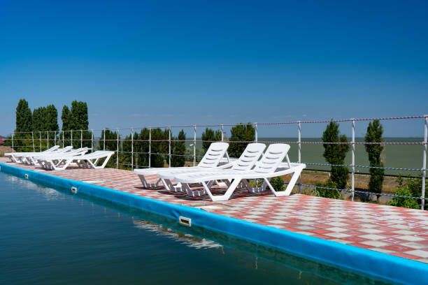 istock deckchairs on blue sky background stand near pool 1267676456