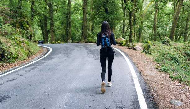istock Young woman hiker with backpack travels outdoors in the mountains 1267677403