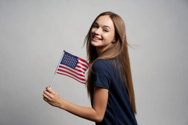 istock Happy female holding America flag 1267680962