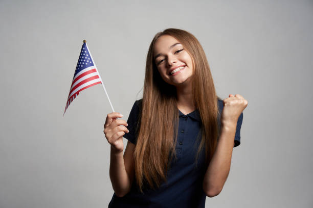 istock Happy female holding USA flag 1267680997