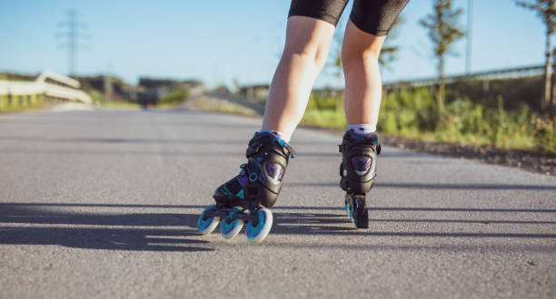 istock Girl is rollerblading along an asphalt alley 1267681046