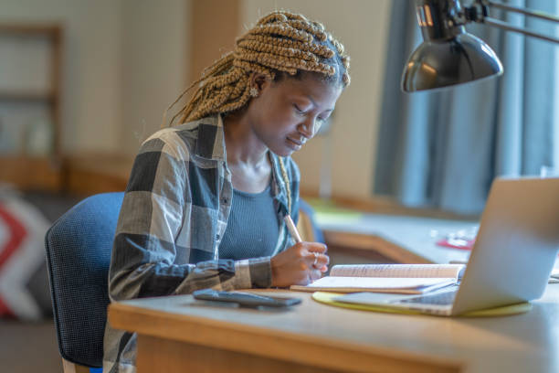 istock Female students working in dorm room 1267681151