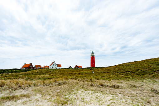 The red lighthouse on the North end of the island of Texel near the village of De Cocksdorp. Texel is the largest island of The Netherlands in the Waddenzee, an Unesco world heritage site.