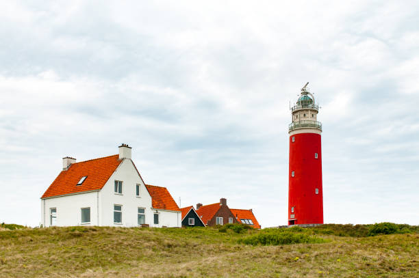 istock Lighthouse and some houses on Texel 1267682300