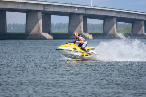 Lelystad, The Netherlands- May 01, 2009: Man having fun on Jet Ski near Dutch Ketel Bridge