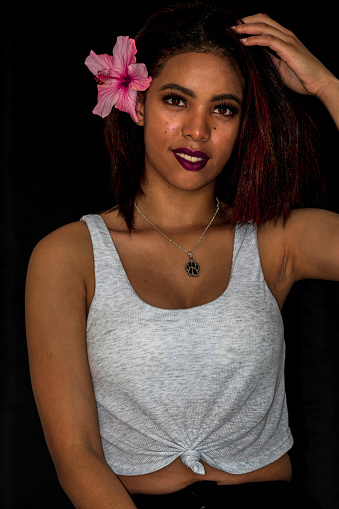 Cropped shot of an attractive young woman posing against a black background in the studio