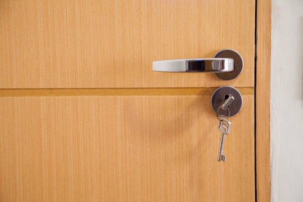 istock cleaning the door handle for coronavirus prevention during normal new quarantine 1267690838