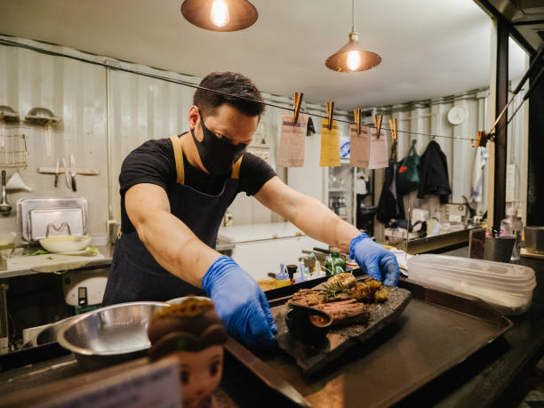 Business owner reopening a restaurant while wearing a facemask