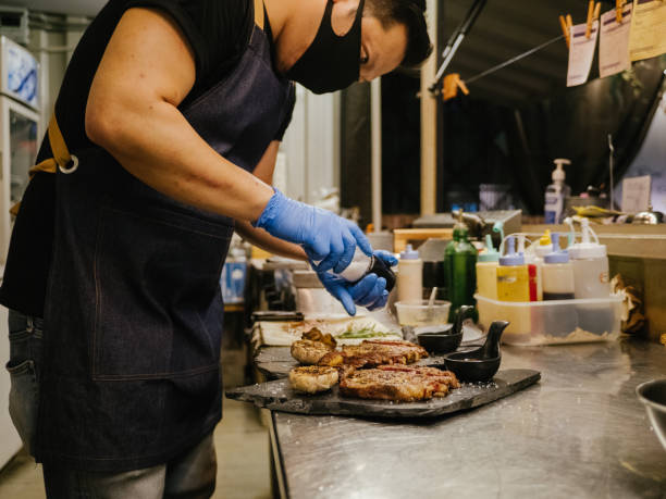 istock Chef cooking meat at professional kitchen. 1267695548