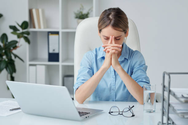 istock Contemporary businesswoman keeping her hands by face while brainstorming 1267696883