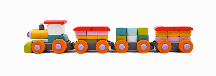Close up one wooden painted colorful toy train isolated on white background, low angle, side view