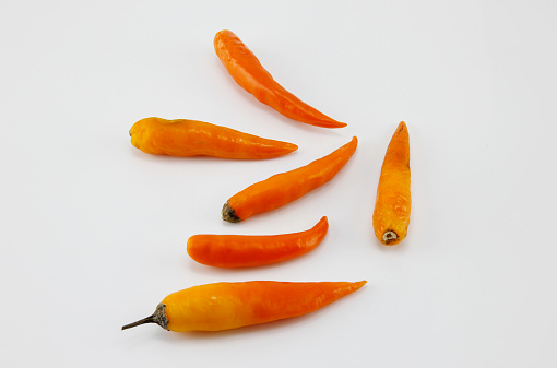 Yellow peppers placed on a white background.