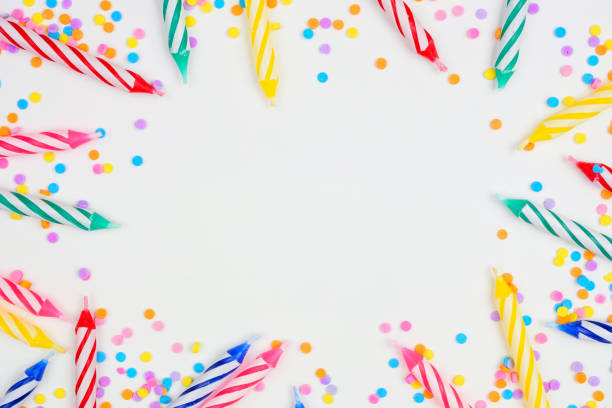 istock Birthday cake candles with candy sprinkles. Frame on a white background. 1267699537