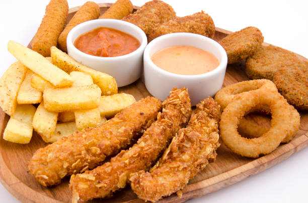 istock fried snacks on wooden platter on back white background 1267700986