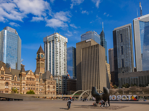 Toronto, Canada - May 16, 2020:  Nathan Phillips Square , skyscrapers and high - rise buildings of the Financial district on a weekend  during the COVID 19 lockdown
