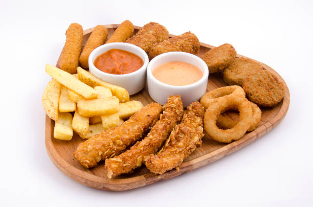 istock fried snacks on wooden platter on back white background 1267701988