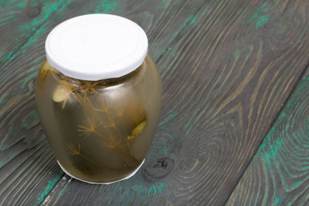 istock Jar of pickled cucumbers. On a painted board surface. 1267702137