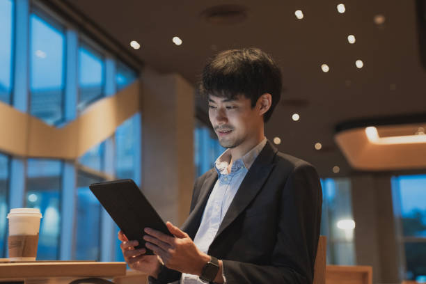 istock Businessman at work. man working on tablet while sitting at the wooden desk 1267703173