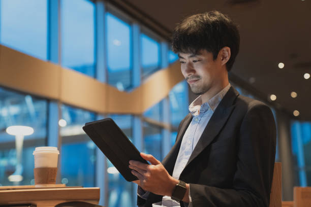 istock businessman think of online project looking at tablet at workplace 1267703195