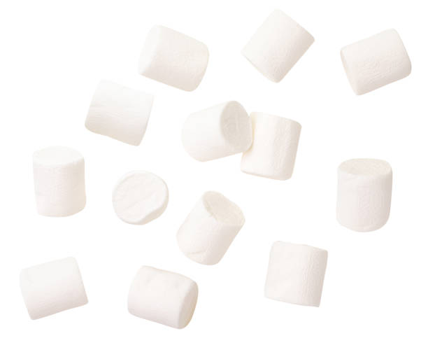 Chewing marshmallow flies on a white background. Isolated Chewing marshmallow close-up flies on a white background. Isolated marshmallow photos stock pictures, royalty-free photos & images