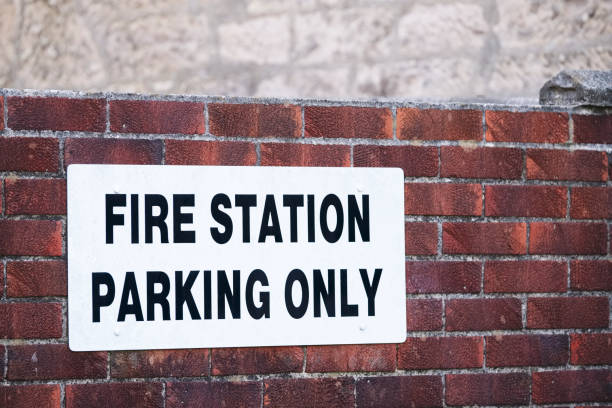 istock Fire station parking only on wall car park sign 1267707398