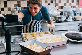 A man blogger live cooking at kitchen for working from home. COVID-19