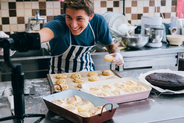 człowiek blogger na żywo gotowania w kuchni do pracy z domu. covid-19 - chef cooking food pan zdjęcia i obrazy z banku zdjęć