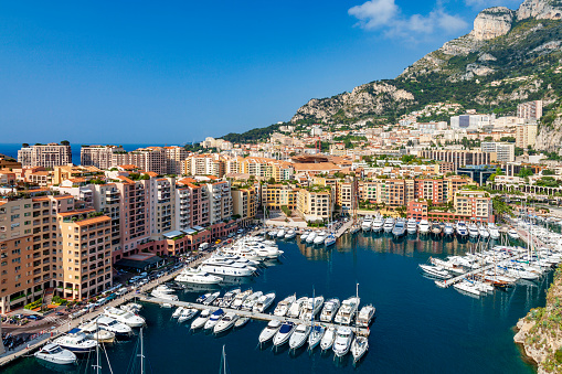Aerial view of Port de Fontvieille - Monte Carlo in Monaco where, in addition to the Grande Casino, you see Yachts, Condominiums, Hotels, Mountains and Money which are all the symbols of this famous City.