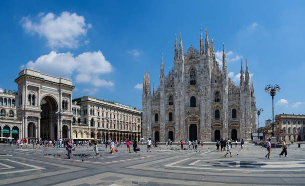 milano, italy. the main facade of the dome and the square. the famous cathedral in milan. the church is a main landmark of the town. few people at the square because of the covid-19 or coronavirus - dome milan italy architectural feature italy imagens e fotografias de stock