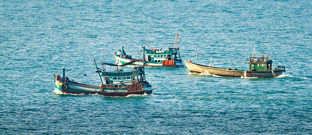Kampot, Cambodia - January 22, 2019: Colorful fishing boats in Kampot, Cambodia