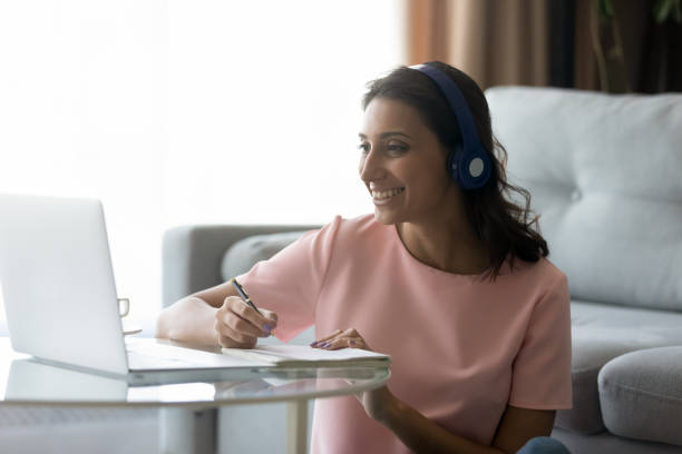 istock Smiling indian woman study watch webinar on laptop 1267716529
