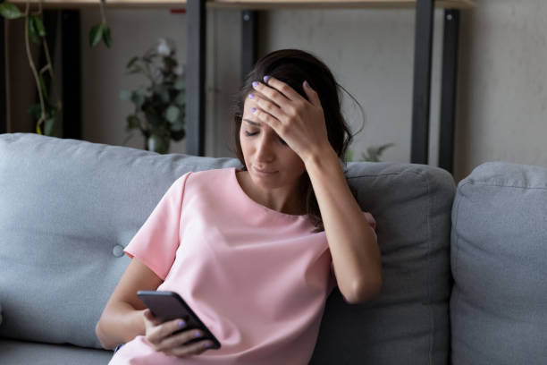 istock Upset young woman frustrated by negative message on cellphone 1267716543