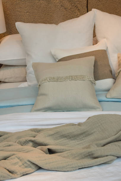 istock Made bed with pastel color pillows and bedspread 1267717728