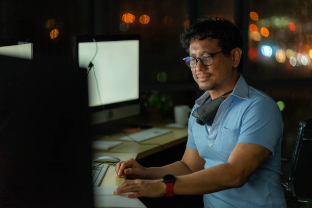 istock Engineering technical worker working at night or what time with the computer monitor and headphone in the office 1267718480