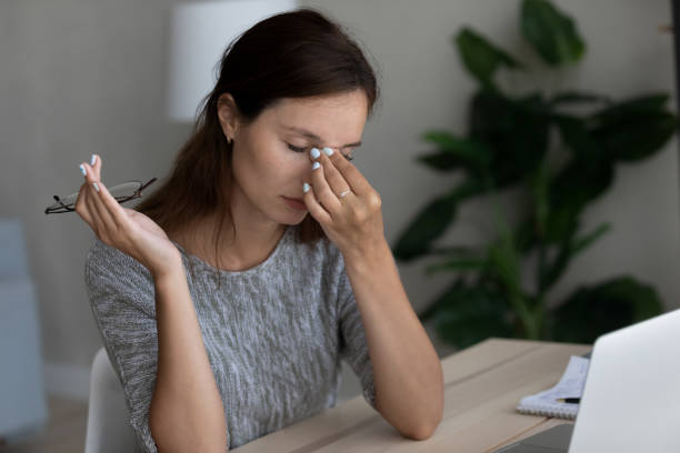 istock Unhealthy young woman having headache at workplace 1267719527