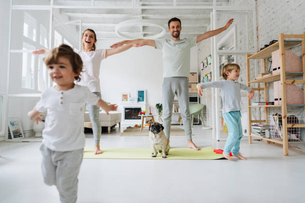 istock Young family exercising at home 1267719710