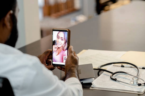 istock Male doctor speaking with patient via video chat 1267720811