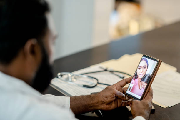 istock Male doctor speaking with patient via video chat 1267720830