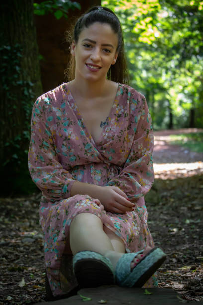istock the girl is sitting on a stump 1267720948