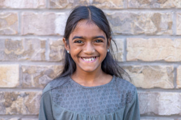 istock Cute 8 year old girl smiling at the camera 1267725992