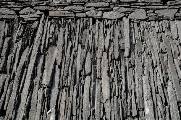 Stones of metamorphic origin arranged as part of a sea defence wall.  Quntin Bay, County Down, Northern Ireland.