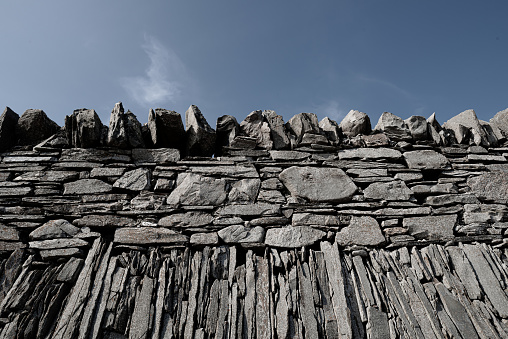 Stones of metamorphic origin arranged as part of a sea defence wall.  Quntin Bay, County Down, Northern Ireland.