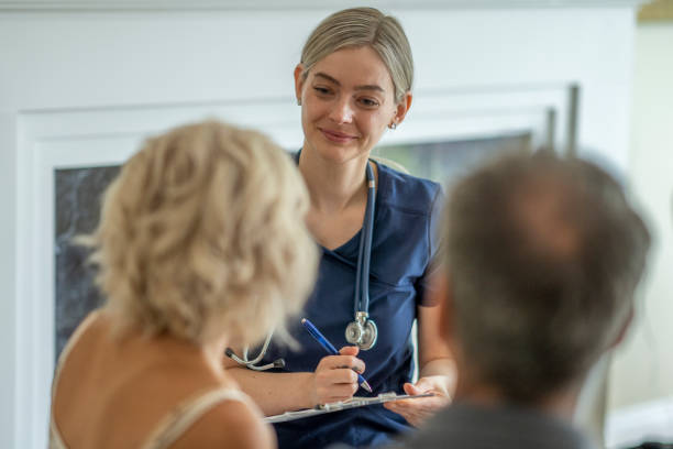 istock Female medical professional on a house call 1267728096