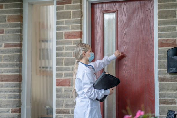 istock Female medical professional making a house call 1267728103
