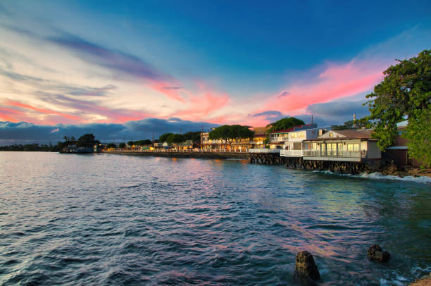 Front Street downtown district in Lahaina on Maui at sunset. Pink sky sunset over Front Street in Lahaina on Maui. maui stock pictures, royalty-free photos & images