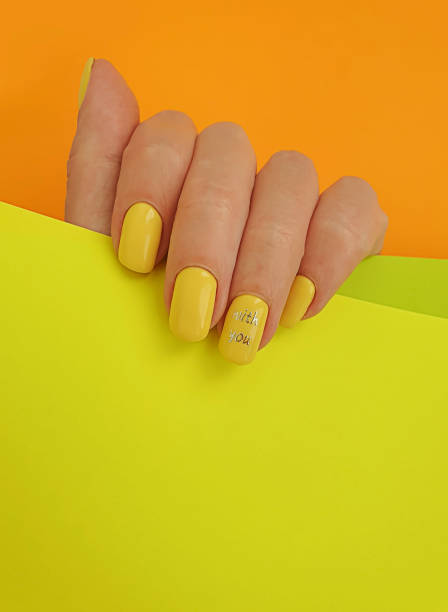 istock female hand beautiful manicure on colored background 1267730078