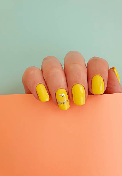 istock female hand beautiful manicure on colored background 1267730356
